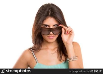 Woman wearing sunglasses and posing isolated over a copy space background