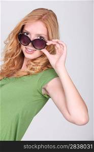 Woman wearing sunglasses in studio