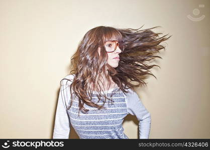 Woman wearing sunglasses tossing hair