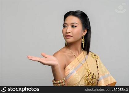 woman wearing Thai dress that made a hand symbol