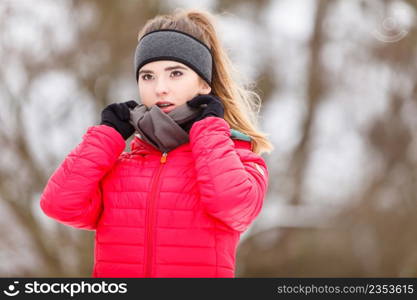 Woman wearing warm sportswear getting ready before exercising, running jogging outside during winter.. Woman wearing sportswear exercising during winter