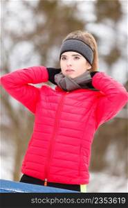 Woman wearing warm sportswear getting ready before exercising, running jogging outside during winter.. Woman wearing sportswear exercising during winter