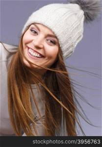 woman wearing winter wool cap portrait. Attractive happy smiling woman long hair girl in winter wool cap studio shot on violet.