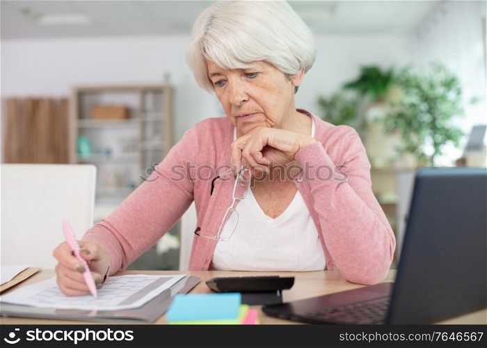 woman wearing works on a laptop