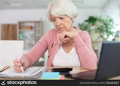 woman wearing works on a laptop