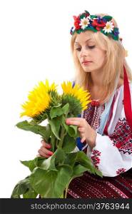 Woman wears Ukrainian national dress is holding a sunflower