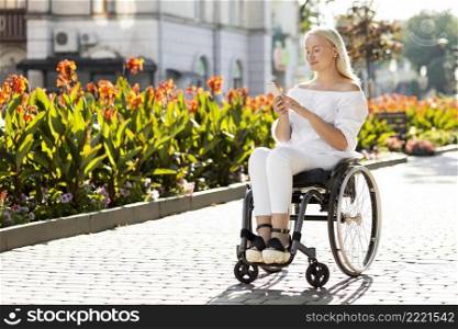 woman wheelchair city using smartphone with copy space