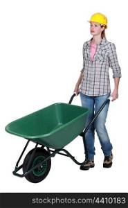 Woman wheeling wheelbarrow