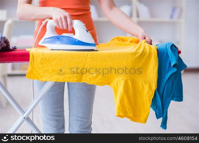Woman wife doing ironing at home