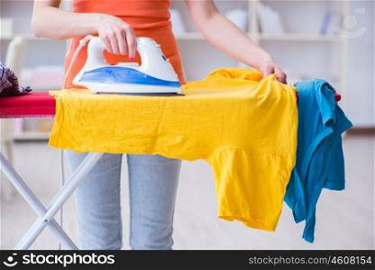 Woman wife doing ironing at home