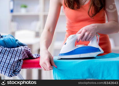 Woman wife doing ironing at home