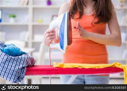 Woman wife doing ironing at home. The woman wife doing ironing at home