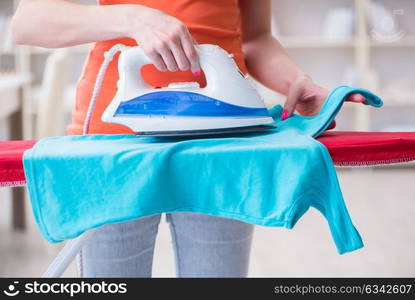 Woman wife doing ironing at home. The woman wife doing ironing at home