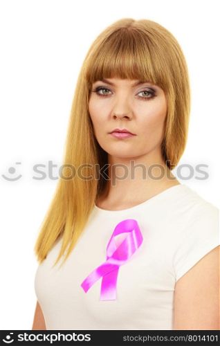 Woman wih pink cancer ribbon on chest. Sad, worried and concerned facial expression. Health care, medicine and breast cancer awareness concept.