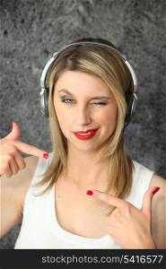 Woman winking with audio headphones