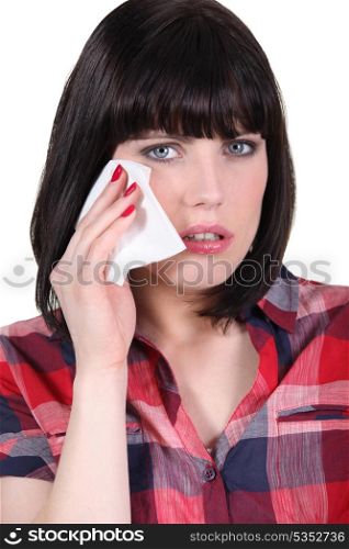 Woman wiping away a tear