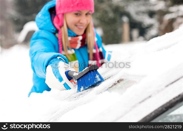 Woman wiping snow car window using brush winter happy work