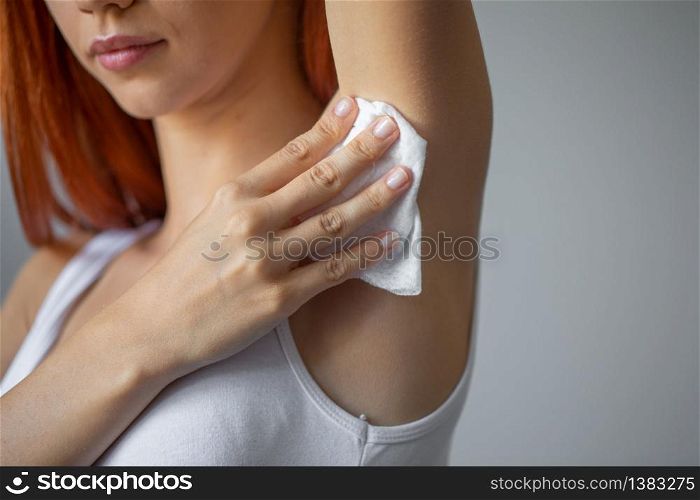 Woman wiping the armpit with wet wipes, perspiration, sweat remove