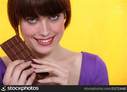 Woman with a bar of chocolate