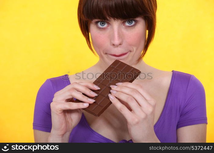 Woman with a bar of chocolate