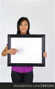 Woman with a blank picture frame