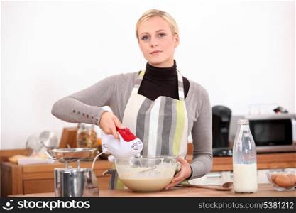 Woman with a blender in the kitchen