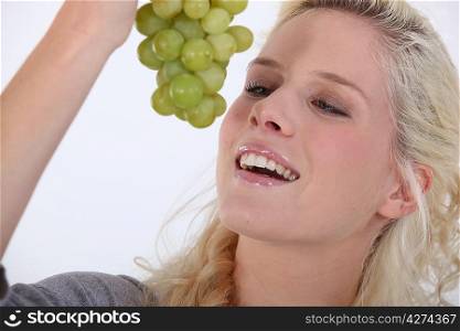 Woman with a bunch of grapes