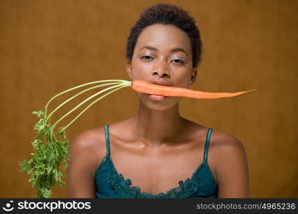 Woman with a carrot in her mouth
