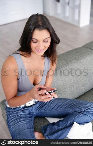 Woman with a cellphone on the sofa
