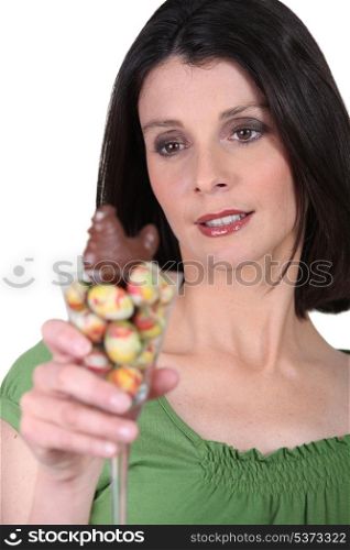 Woman with a cocktail glass full of Easter eggs