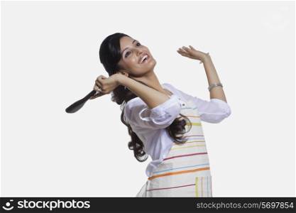 Woman with a cooking utensil rejoicing