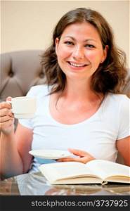 woman with a cup of coffee smiling