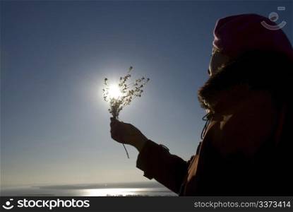 woman with a flower in the sun