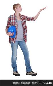 Woman with a hardhat holding empty copyspace