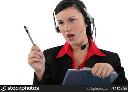Woman with a headset and clipboard