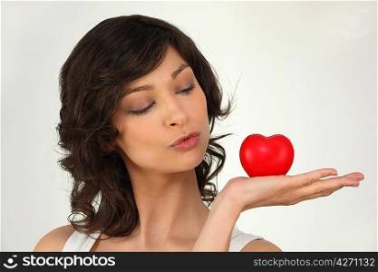 Woman with a heart laying on the palm of her hand