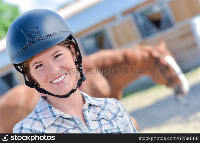 woman with a horse in the background