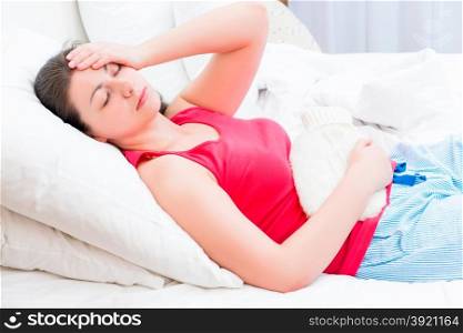 woman with a hot water bottle feels bad