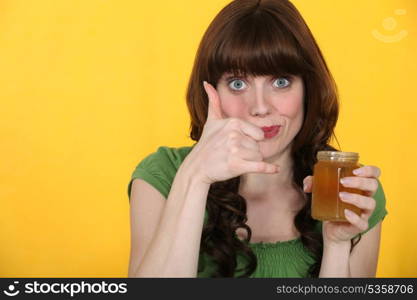 Woman with a jar of honey