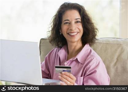 Woman with a laptop computer making an online purchase with credit card