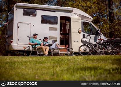 Woman with a man resting near motorhomes in nature. Family vacation travel, holiday trip in motorhome RV, Caravan car Vacation.