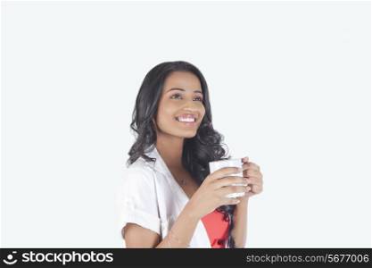 Woman with a mug of tea smiling