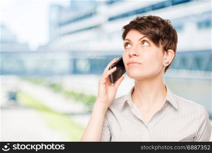 woman with a phone looking at white space in the office