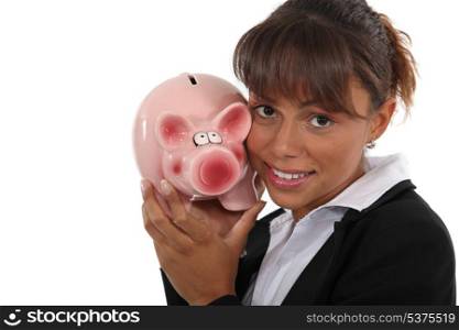 Woman with a piggy bank in hand
