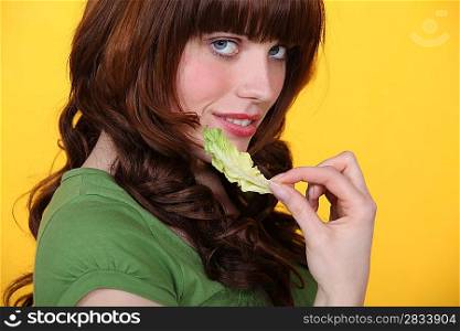 Woman with a salad leaf