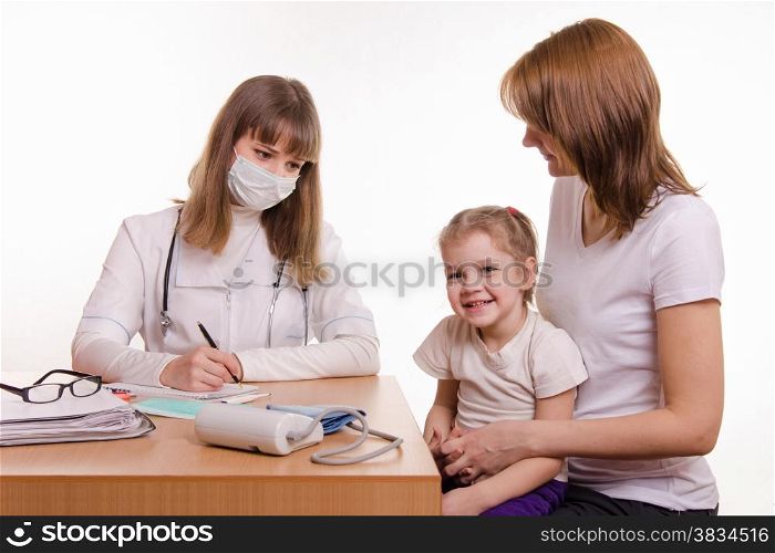 Woman with a small child on reception at the pediatrician