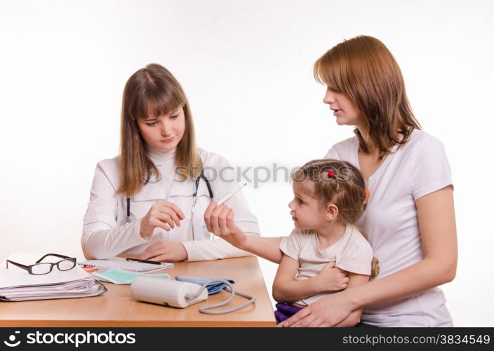Woman with a small child on reception at the pediatrician
