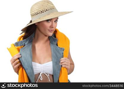 Woman with a towel and suncream