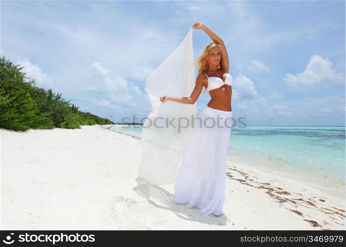 woman with a white cloth in his hands on the beach