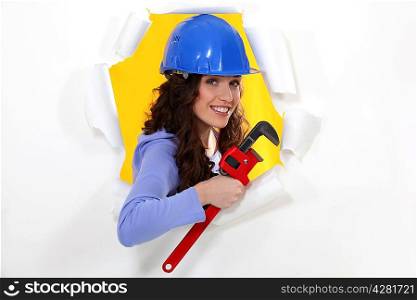 Woman with a wrench and hardhat